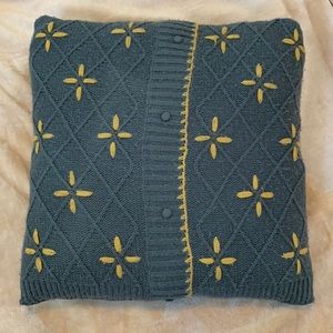 Green/gray knit sweater pillow with mustard yellow details